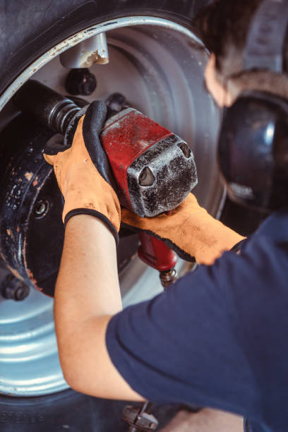 istock Close-up of farm machine mechanic working on wheel 1205782312