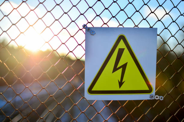 istock Symbol electricity on the fence at sunset. 1205782313