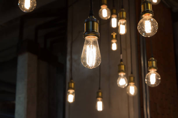 vintage light bulbs hanging from ceiling for decoration in living room. loft decoration style. vintage light bulbs hanging from ceiling for decoration in living room. loft decoration style. light bulb photos stock pictures, royalty-free photos & images