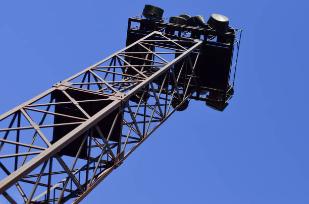 Old rusty metal construction with a ladder leading into the sky against the background of clouds. Nebroshlenny searchlight, lighting, lantern, lamps