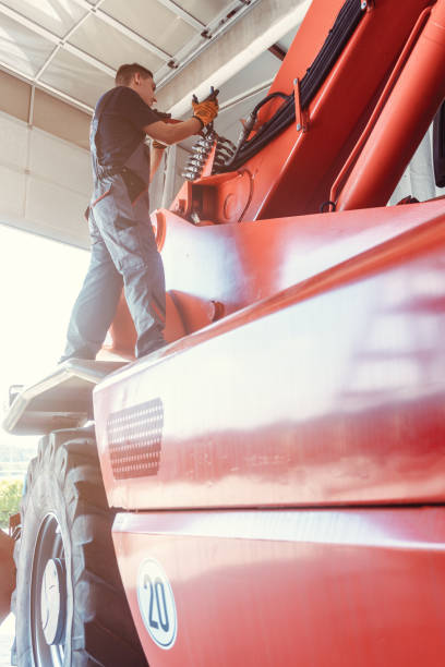 istock Machinist repairing a huge farm machine in his garage 1205783021