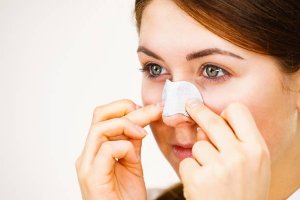istock Woman applying pore strips on nose 1205785241