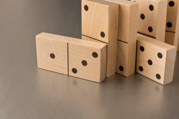 istock Playing dominoes on a silver background. Leisure games concept. Domino effect. 1205785450
