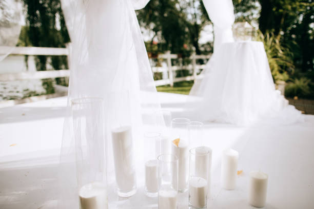 istock White wedding arch decorated with white flowers and candles 1205785563