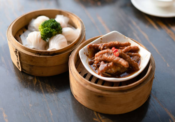 istock tradition Chinese prawn dumplings and chicken feet placed in a bamboo steamer 1205786592