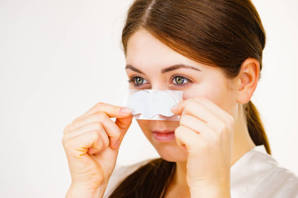 istock Woman applying pore strips on nose 1205786688