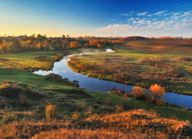 istock autumn river. misty sunrise in a river valley 1205786871