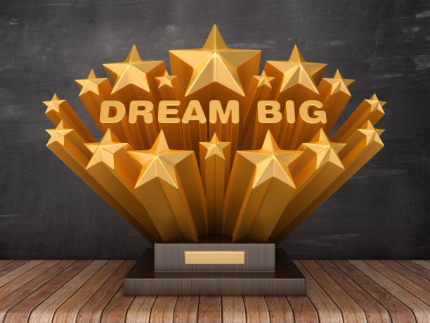 istock Gold Stars with DREAM BIG Phrase on Trophy - Chalkboard Background - 3D Rendering 1205787587