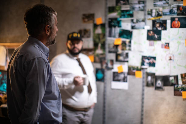 istock Police detectives working up late to solve the case 1205789435