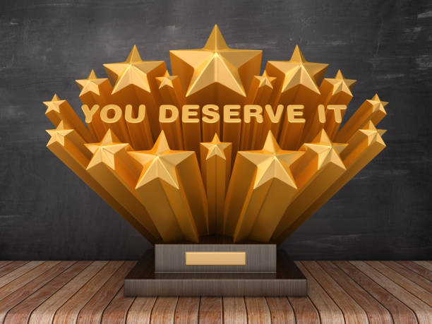 istock Gold Stars with YOU DESERVE IT Phrase on Trophy - Chalkboard Background - 3D Rendering 1205789480