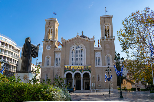 Athens, Greece - December 28 2019: Metropolitan Cathedral of Athens and  statue of Archbishop Damaskinos Papand