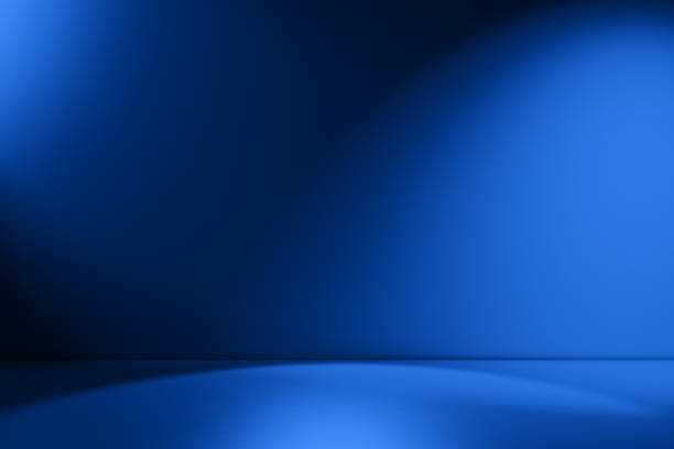 Beams of spotlight on a royal blue background Royal blue empty Studio room for product placement or as a design template with wall angle in a full frame view spot lit photos stock pictures, royalty-free photos & images