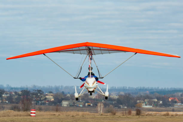 Motorized hang glider flight. Trike flight 2020-02-09 Byshiv, Ukraine. Motorized hang glider flight. Trike flight para ascending stock pictures, royalty-free photos & images