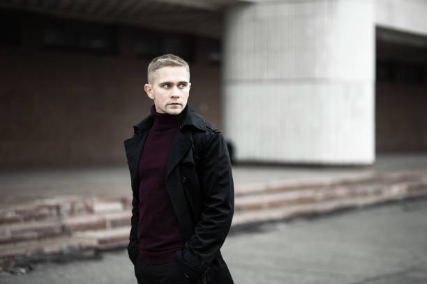 istock Serious man in black trenchcoat 1205792135