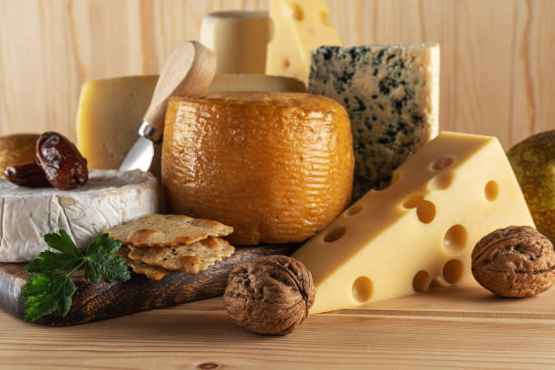 istock Assortment of different cheese types on wooden table. Cheese background. 1205792278