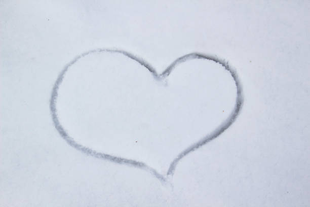 istock Painted heart in the snow against snow background 1205793620