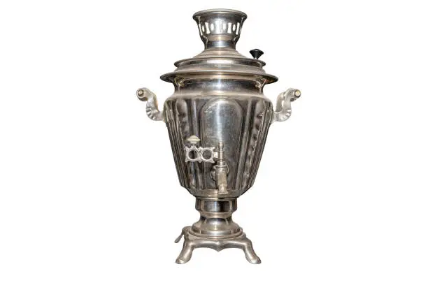 A metal samovar made in the old style for preparing tea, isolated on a white background with a clipping path.