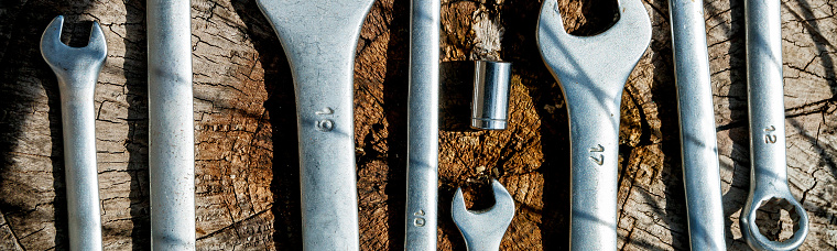 Banner of Bike repair. Tools for repairing bicycle on the on the wooden background. Close up.