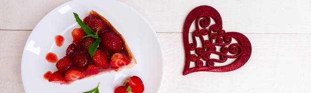istock Banner of Strawberry pie on white plate and white wooden table. 1205795607