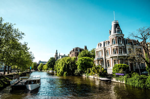 Boat Parked Near House In Amsterdam, The Netherlands