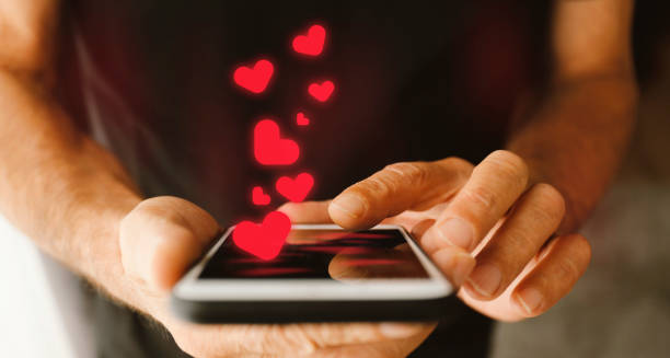 istock Man holding mobile phone with heart shape 1205796957