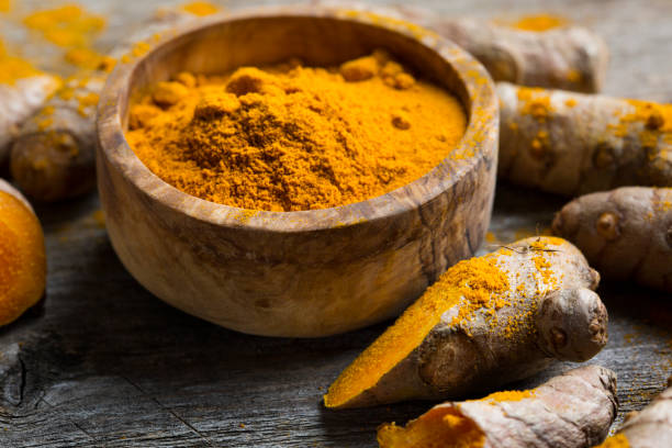istock Curcuma longa, powder and rhizomes 1205797175