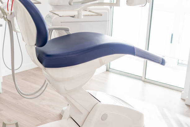 istock blue dentist armchair with instruments in white cabinet 1205798767
