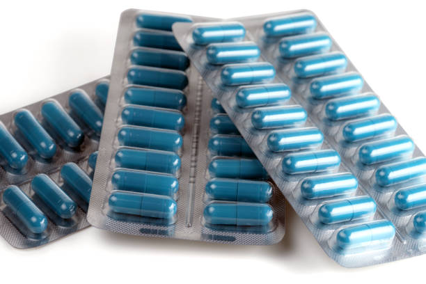 istock Blue medical capsules in blisters isolated on a white background. 1205798794