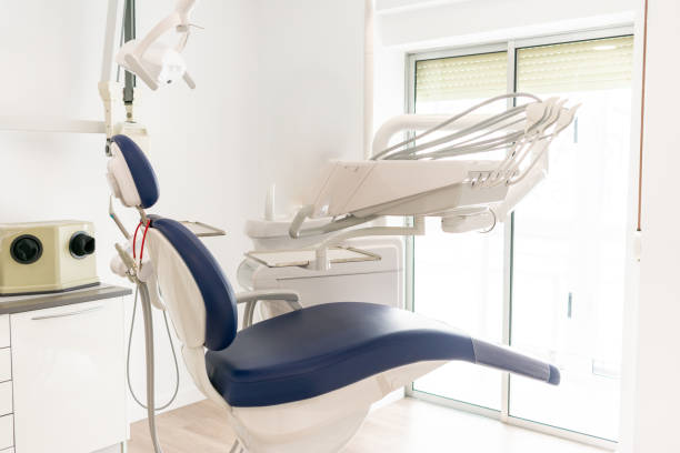 istock blue dentist armchair with instruments in white cabinet 1205798883