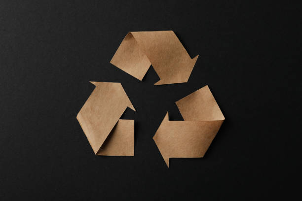 istock Recycling sign on black background, top view 1205802199