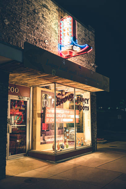 Austin, Texas, USA- February 3, 2020. Colorful neon and murals scenes in the evening on Historic Rainy street Historic District in Austin, capital city of state f Texas in USA. Variety of restaurants, stores and businesses at the street front. Store on city corner.