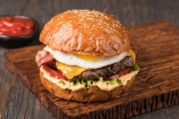istock Burger on a wooden board 1205802526