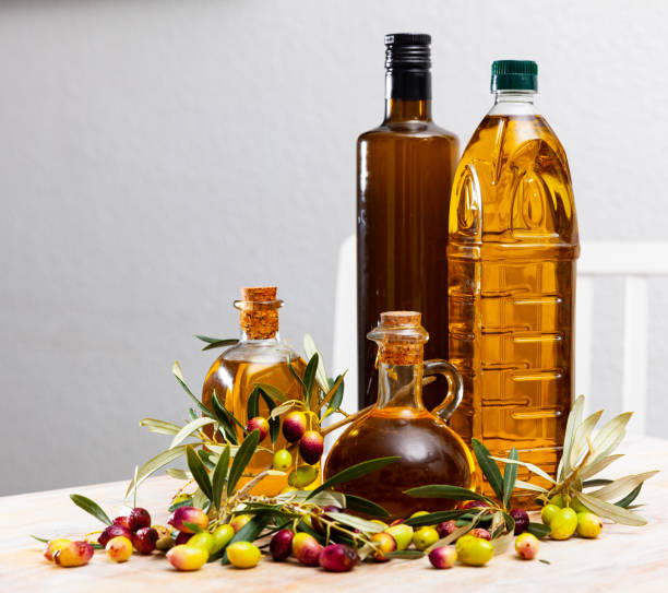 istock Olive oil in bottles on wooden table 1205803623