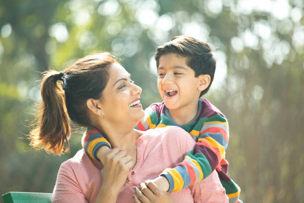 istock Boy embracing mother at park 1205803649