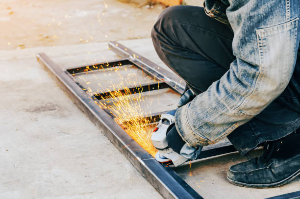 istock Man hands cutting metal with electric circular saw 1205804591
