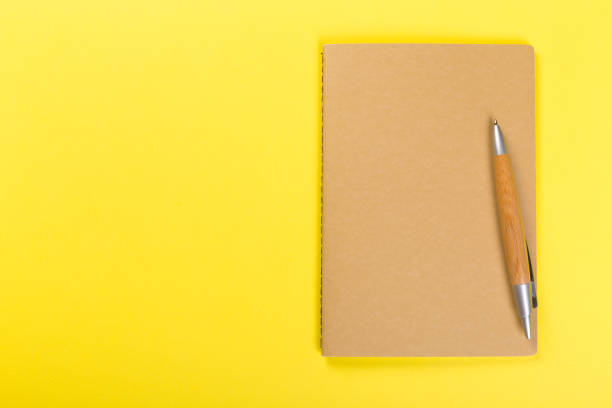 istock Sketchbook on colorful background. Copy space. top view of blank open notebook, concept of education or new workplace 1205805242