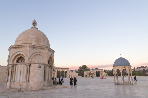 Jerusalem/ Palestine- December 14th, 2017: A beautiful exterior shot of Arab children walking past the Dome of the Rock, one of the most holy sites for the Islam.