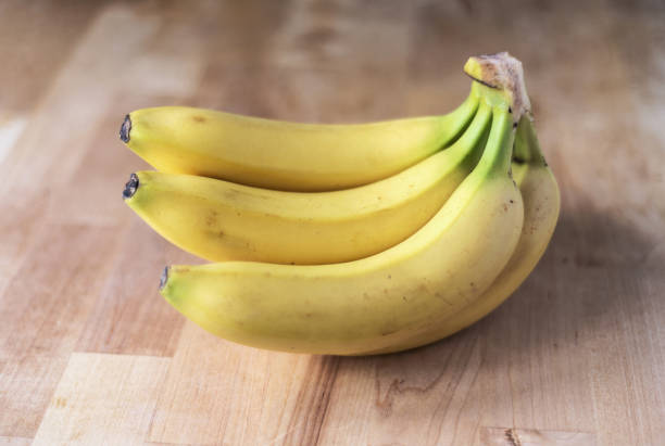 istock Ripe bananas on a wooden surface 1205806594