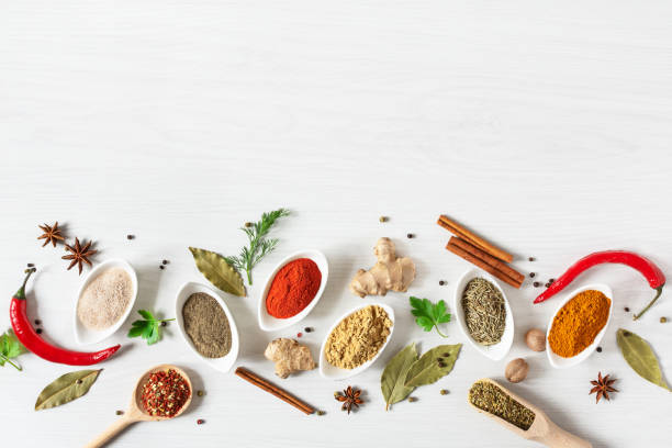 istock Various assorted colorful spices and herbs on white wooden background top view. 1205807499