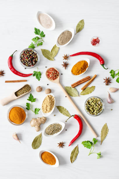 istock Various assorted colorful spices and herbs on white wooden background top view. 1205807531