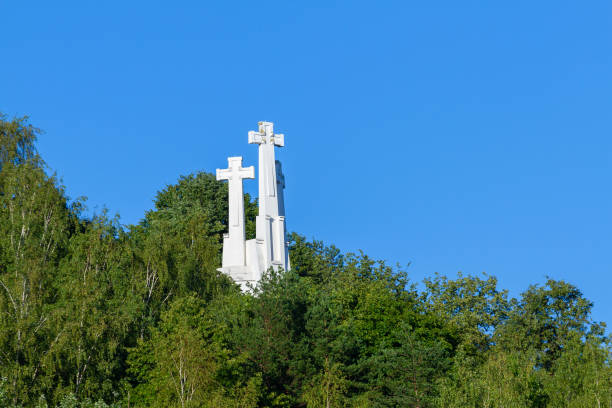 White cross in the Catholic Cemetery of Aznalcazar, Seville, Andalucia, Spain against a clear blue sky, symbolizing faith and serenity.