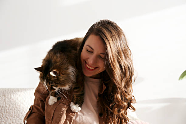 istock Charismatic young woman playing with her adorable cat. 1205809512