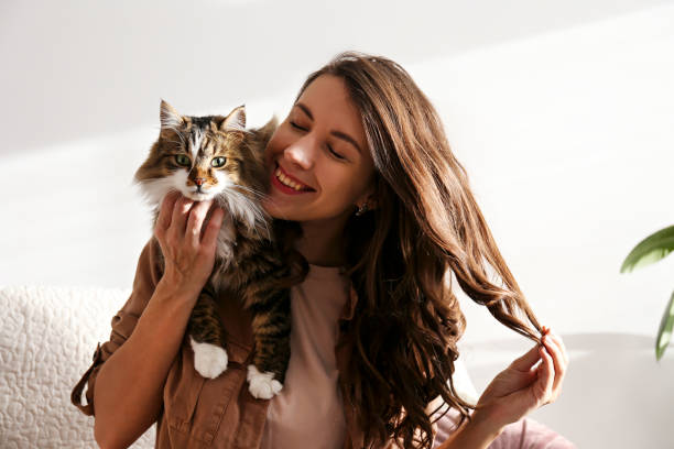 istock Charismatic young woman playing with her adorable cat. 1205810510