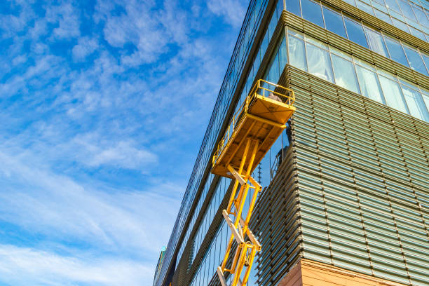 istock Workers on a Scissor Lift Platform at a construction site. Men at work. 1205810712
