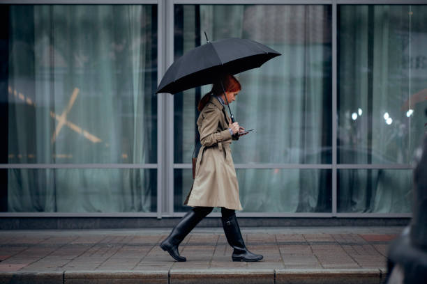 istock A Woman Walking with Umbrella 1205811884