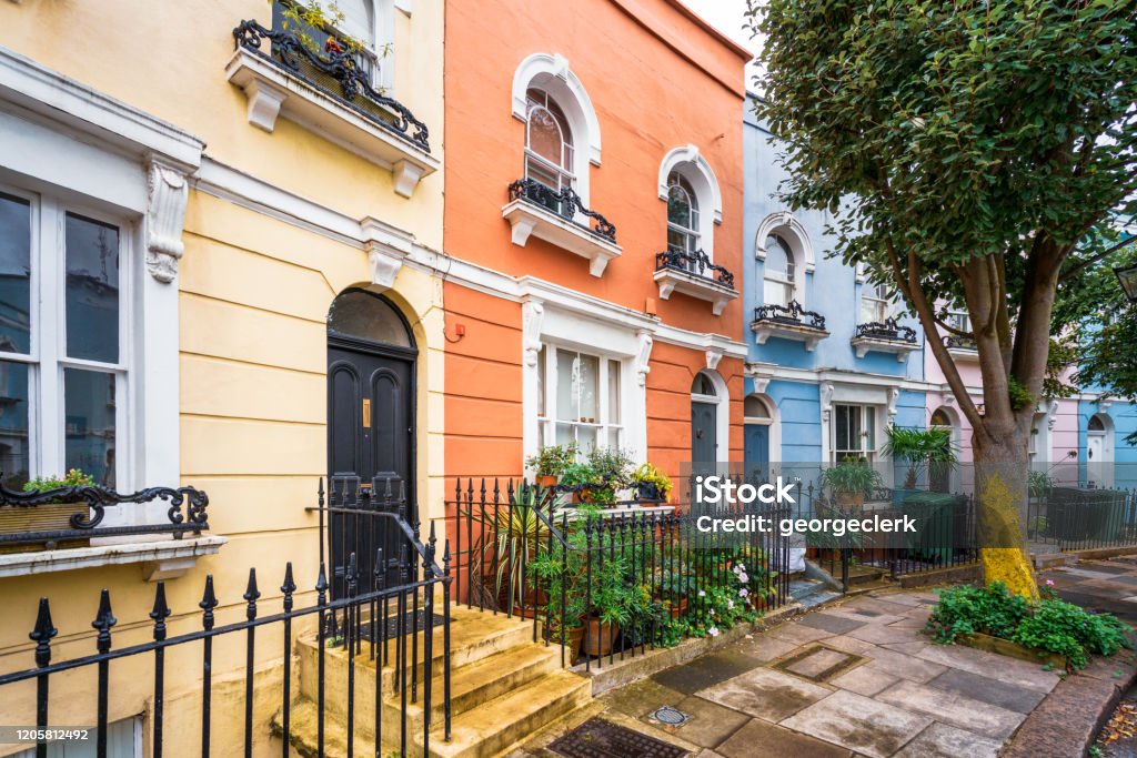 Colourful houses on a curving London street Houses painted in pastel colours in Chelsea, London. Real Estate Stock Photo