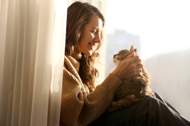 istock Charismatic young woman playing with her adorable cat. 1205812508