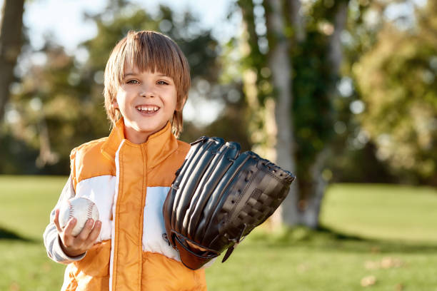 istock Preparing your kid. Little boy is ready to play baseball 1205813513