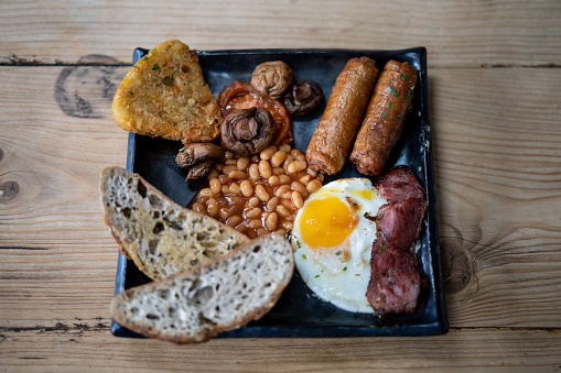 Delicious english breakfast on wooden table at a a restaurant - Close up shot