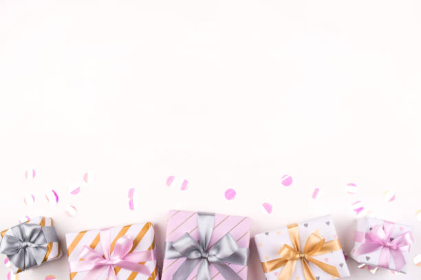 istock Set of gift boxes with bows and confetti on a white background. 1205813897